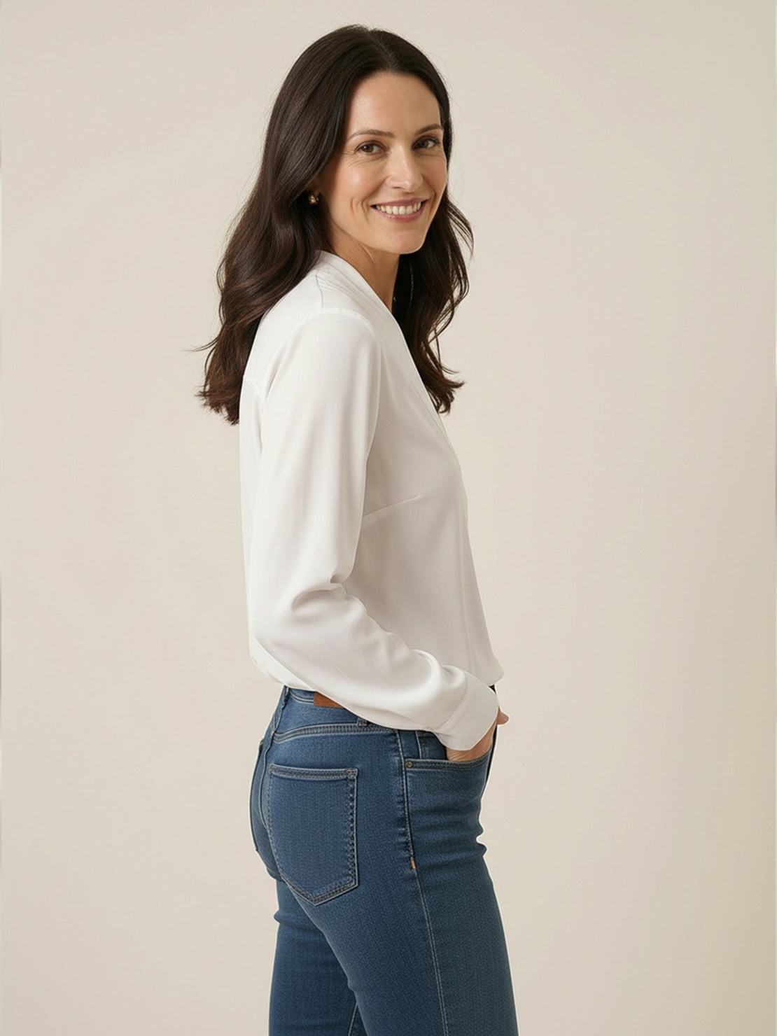 White pleated V-neck long-sleeve blouse with button cuffs and relaxed fit