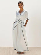 Knot-waist maxi dress with V-neckline, batwing sleeves, and flowing skirt in lightweight fabric