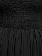 Smocked sleeveless maxi dress with tiered skirt and scoop neckline