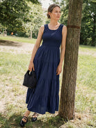 Smocked sleeveless maxi dress with tiered skirt and scoop neckline
