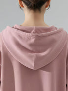 Woman wearing a soft chenille zip-up hoodie and wide-leg pants loungewear set with drawstring waist and side pockets