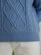 Oversized cable-knit crewneck sweater with dropped shoulders and ribbed trim