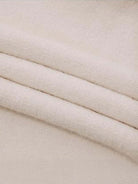 Oversized cable-knit crewneck sweater with dropped shoulders and ribbed trim