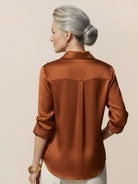 Silk-finish button front shirt with relaxed fit and curved hem