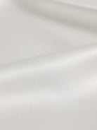 silk-finish button front shirt with traditional collar and curved hem in smooth polyester blend fabric