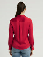 Silk-finish button front shirt with relaxed fit, traditional collar, and smooth fabric draping softly at hip length