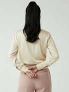 silk-finish button front shirt with smooth fabric and relaxed fit, featuring traditional collar and curved hem