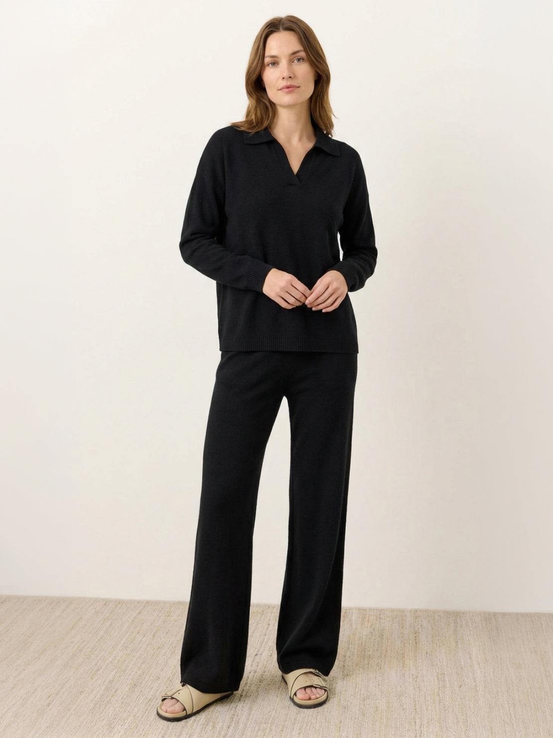 Woman wearing oversized polo knit loungewear set with soft collar and straight-leg pants