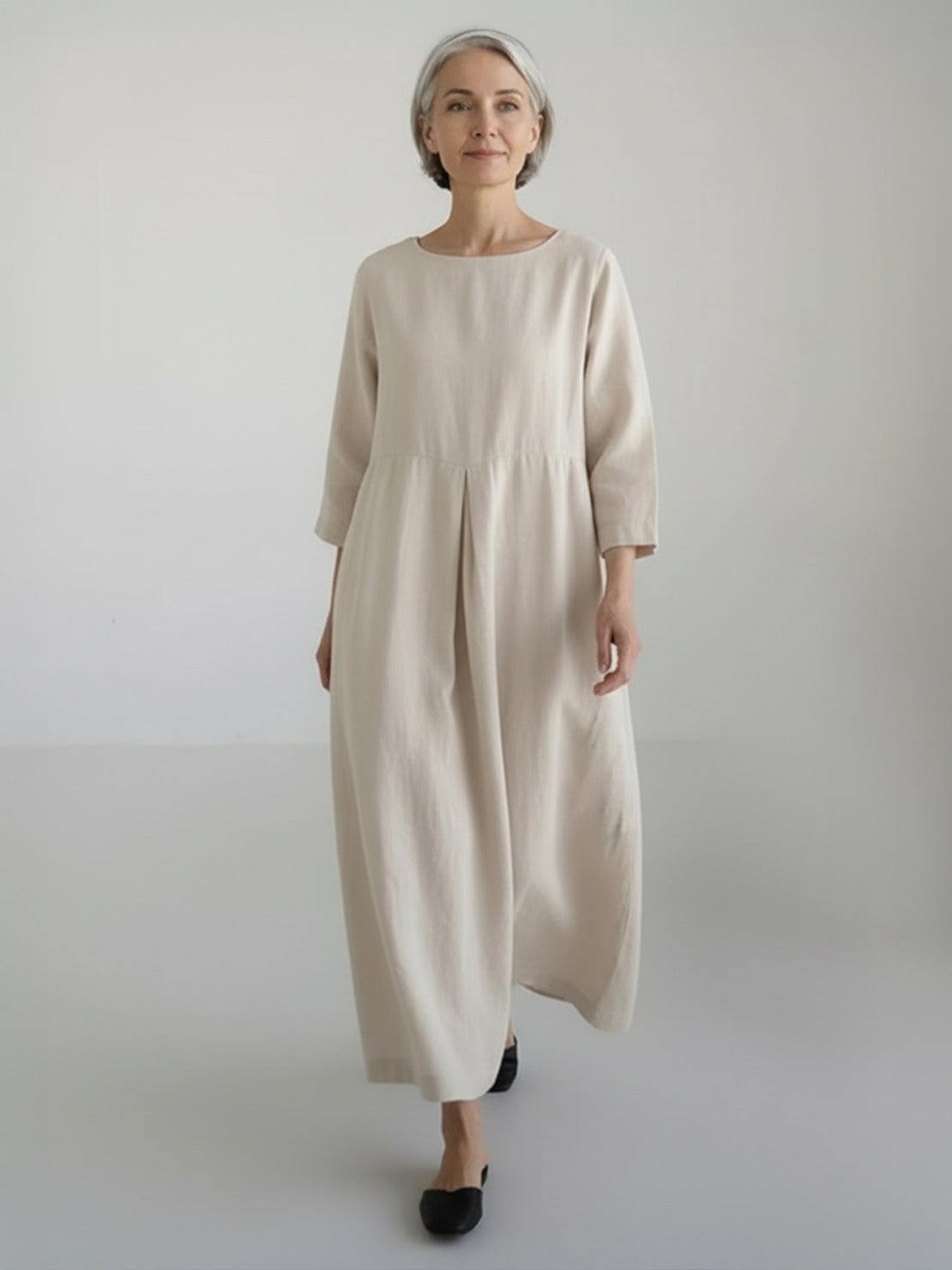Cotton-linen empire waist dress with natural crinkle texture, 3/4 sleeves, and deep side pockets