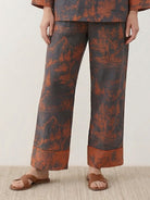 100% cotton Chinese Pankou pajamas set with tunic top and wide-leg pants featuring traditional frog closures and bold landscape print