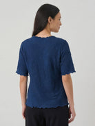 Floral jacquard pleated top with 3D floral texture, flutter sleeves, and relaxed A-line fit