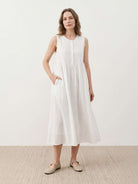 Sleeveless cotton linen pleated midi dress with pintuck bodice and A-line calf-length skirt in relaxed fit