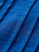 Relaxed A-line 100% cotton linen dress with pintuck pleats, 3/4 sleeves, side pockets, and slits.