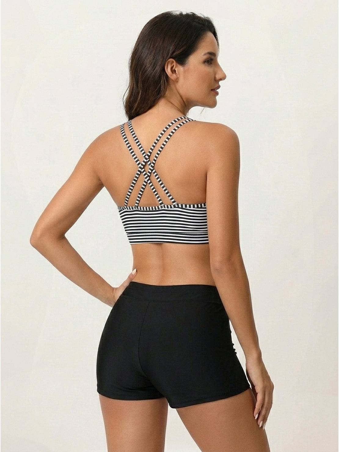 Three-piece tankini set featuring a criss-cross back tank top, printed sports bra, and matching boy shorts.