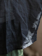 Oversized 100% linen blouse with frog-button closure and curved hem in lightweight fabric