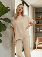 Woman wearing cotton-blend capelet top with batwing sleeves and wide-leg pants lounge set