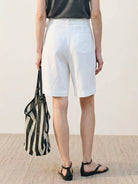 white high-rise linen belted wide-leg shorts with front pleats and covered buckle belt