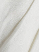 White linen belted shorts with high-rise waist and wide-leg relaxed fit