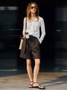 White 100% linen belted shorts with high-rise waist and relaxed wide-leg fit