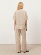 Women wearing 100% cotton relaxed fit two-piece set with button-front top and wide-leg pants in soft solid color