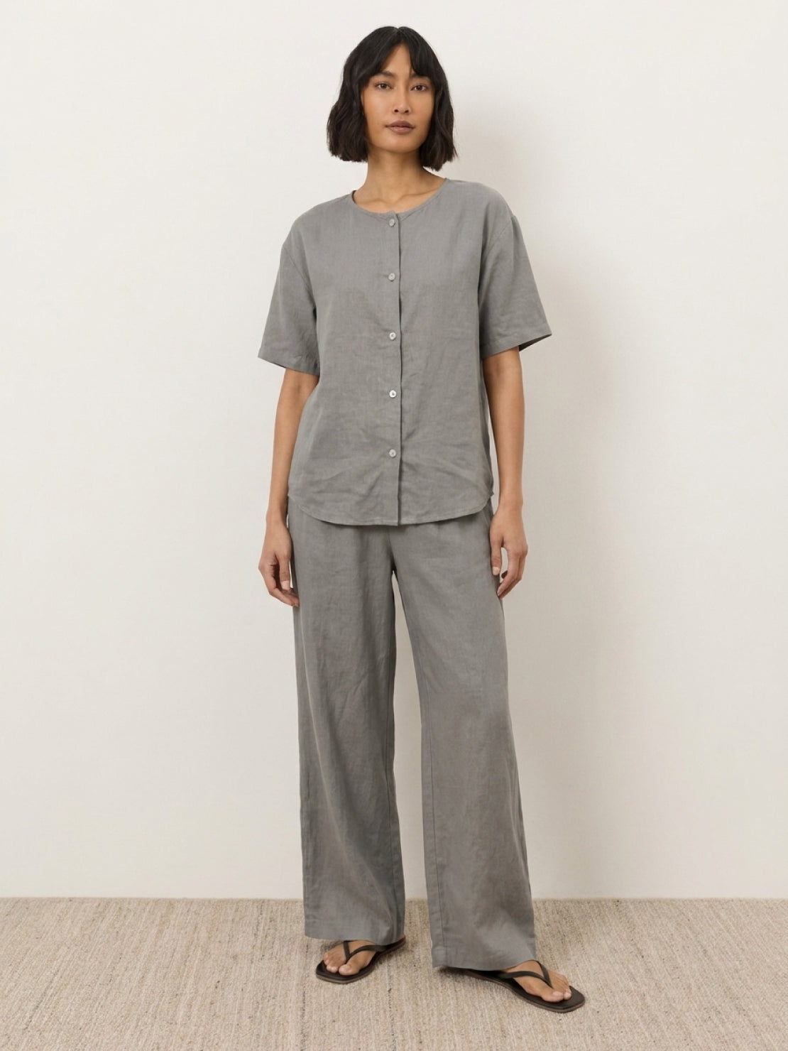 Women wearing 100% cotton two-piece set with button-front top and wide-leg pants in soft solid colors