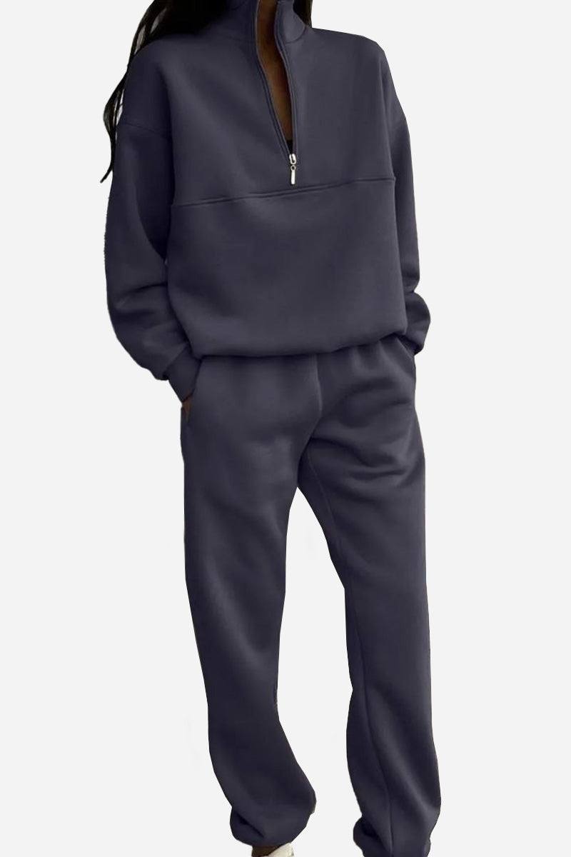 Woman wearing a cotton-blended two-piece tracksuit with high collar and deep zipper in a relaxed silhouette