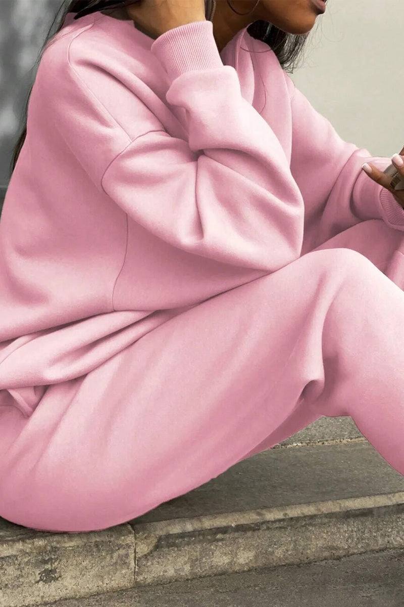 Woman wearing a comfortable cotton-blended two-piece tracksuit with high collar and zipper in monochrome design