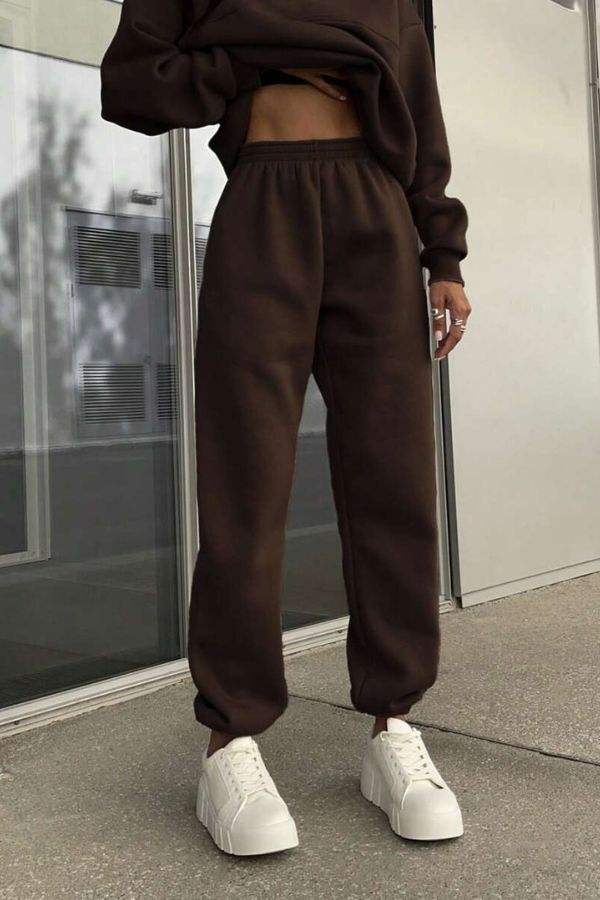woman wearing cotton-blended two-piece tracksuit with high collar and zipper, monochrome athleisure outfit