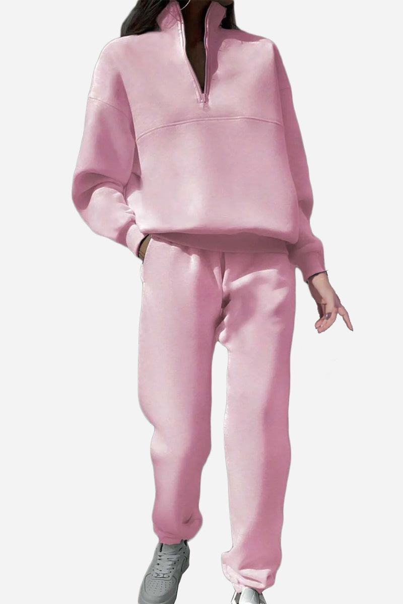 Woman wearing a comfortable cotton-blended two-piece tracksuit with high collar and deep zipper in monochrome design