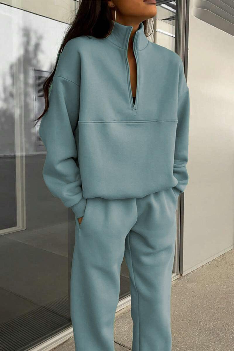 Woman wearing a comfortable cotton-blended two-piece tracksuit with high collar and zipper in monochrome design