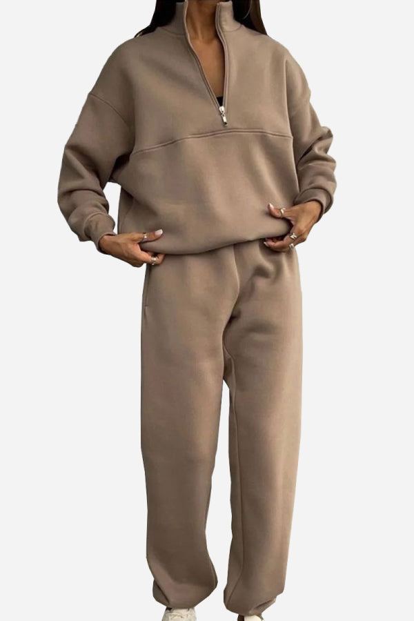 Woman wearing a soft cotton-blended two-piece tracksuit with high collar and zipper, showcasing relaxed monochrome athleisure style