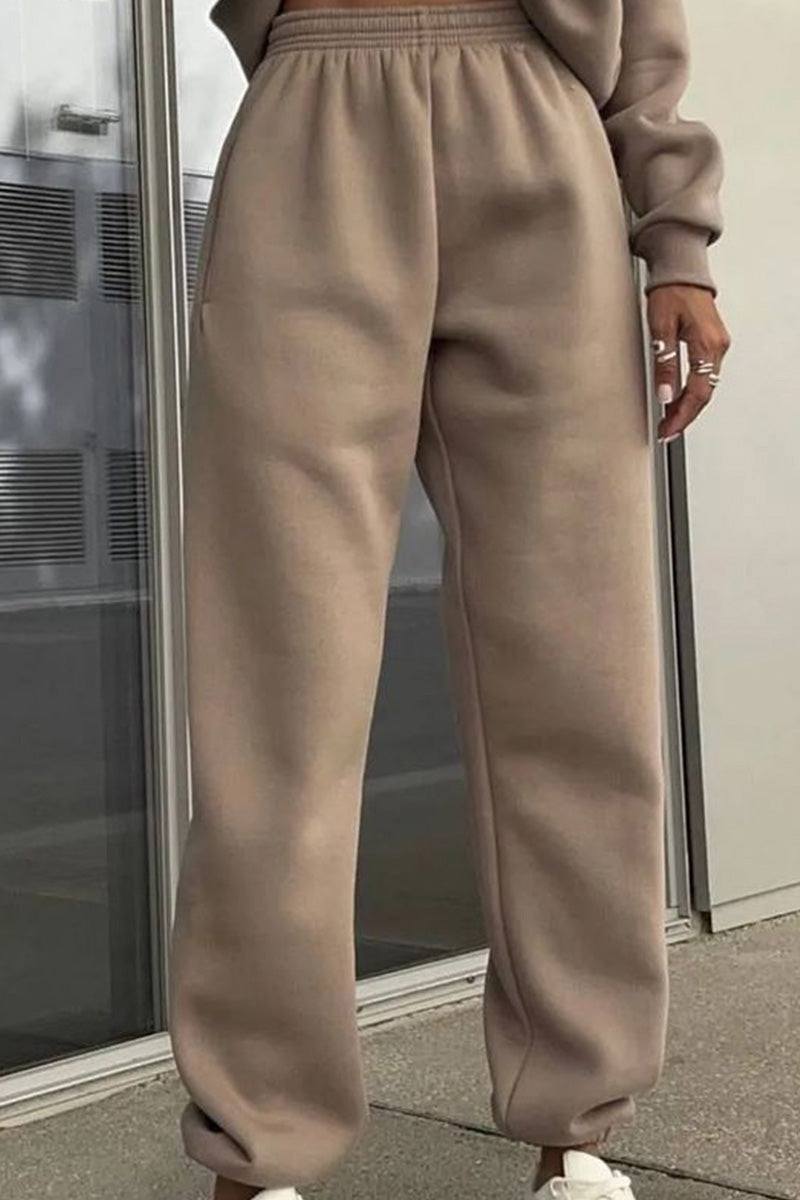 Woman wearing a soft cotton-blended two-piece tracksuit with high collar and deep zipper in monochrome design