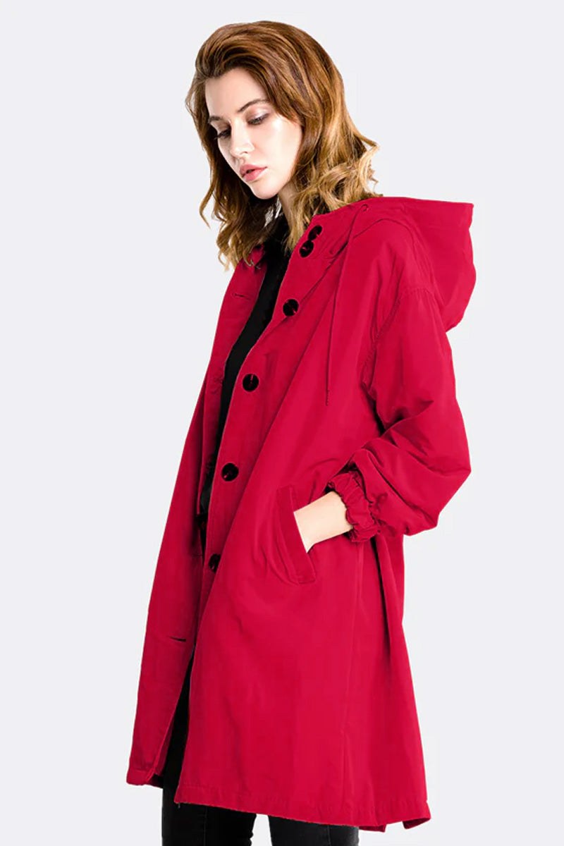 Red water resistant oversized hooded windbreaker rain jacket for women with button closure and pockets