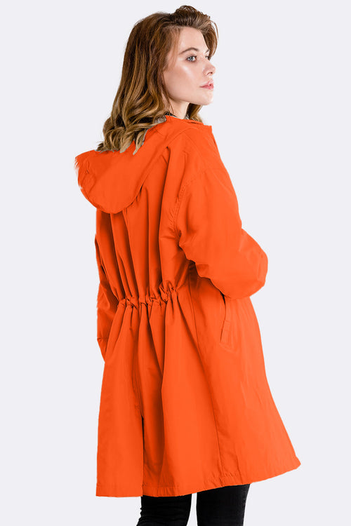 Orange oversized water-resistant windbreaker jacket with hood and adjustable waist, rear view.