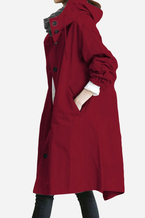 Red oversized water-resistant windbreaker rain jacket with hood and pockets