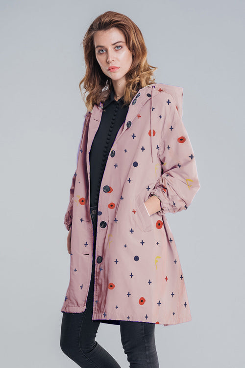 Water-resistant oversized pink hooded windbreaker jacket with abstract pattern on female model