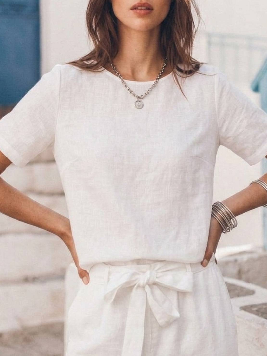 Woman wearing relaxed cotton linen set with short-sleeve top and straight-leg pants in monochrome tones
