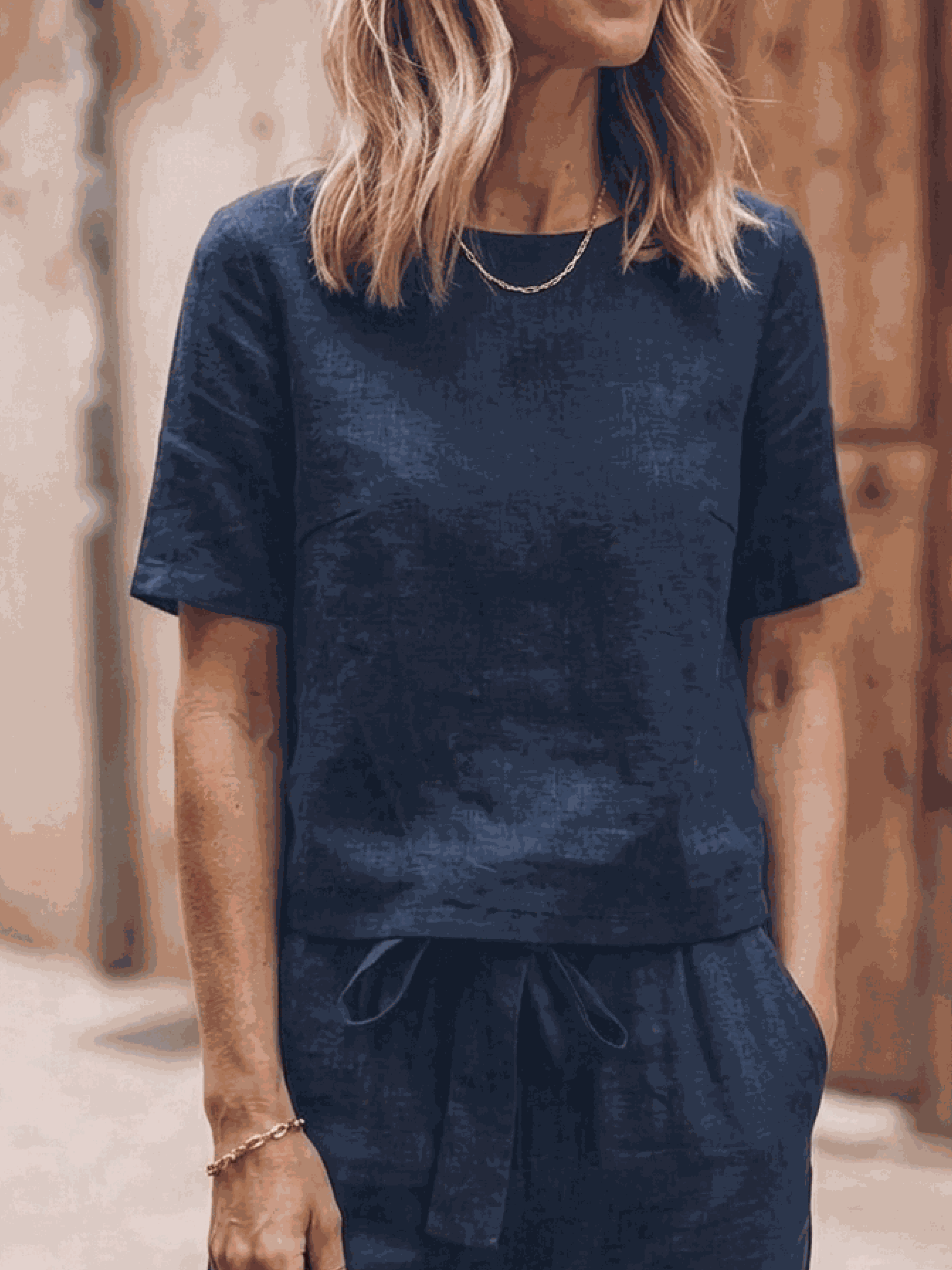 Woman wearing relaxed cotton-linen set with short sleeve top and straight-leg pants in monochrome hues