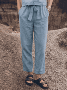 woman wearing relaxed cotton-linen set with short-sleeve top and straight-leg pants in neutral monochrome tone