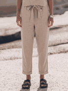 neutral-toned cotton-linen set with relaxed short-sleeve top and straight-leg pants on white background