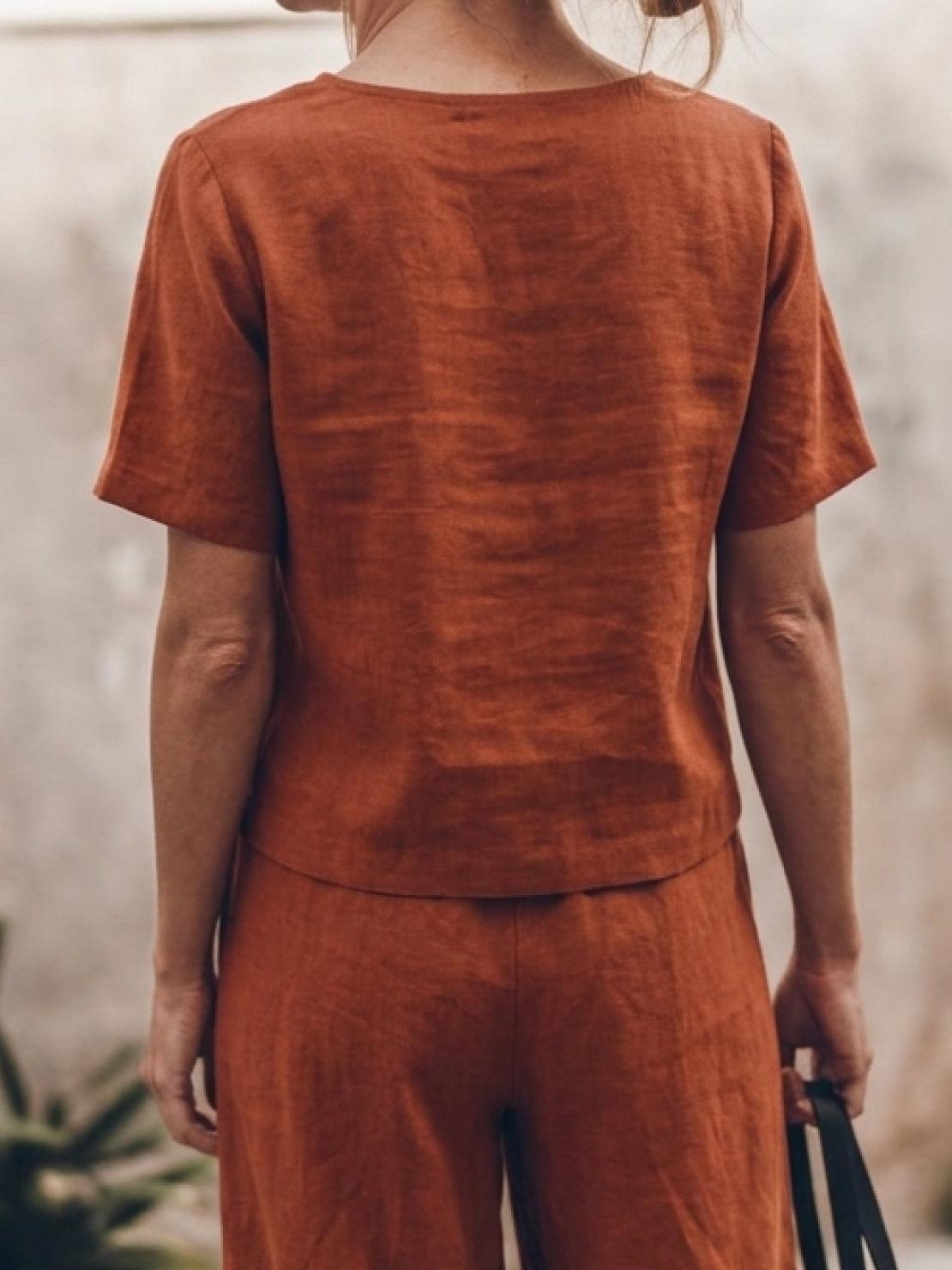 woman wearing soft-tailored loose fit co-ord set with wide-leg cotton trousers and short sleeves
