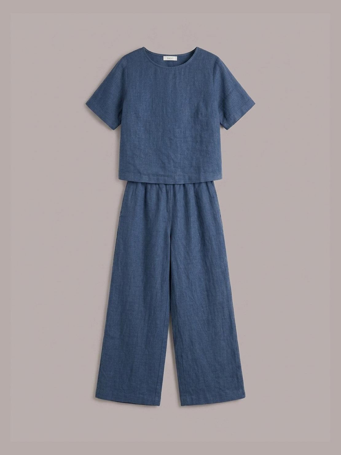 woman wearing loose fit co-ord set with boxy top and wide-leg trousers in soft cotton fabric