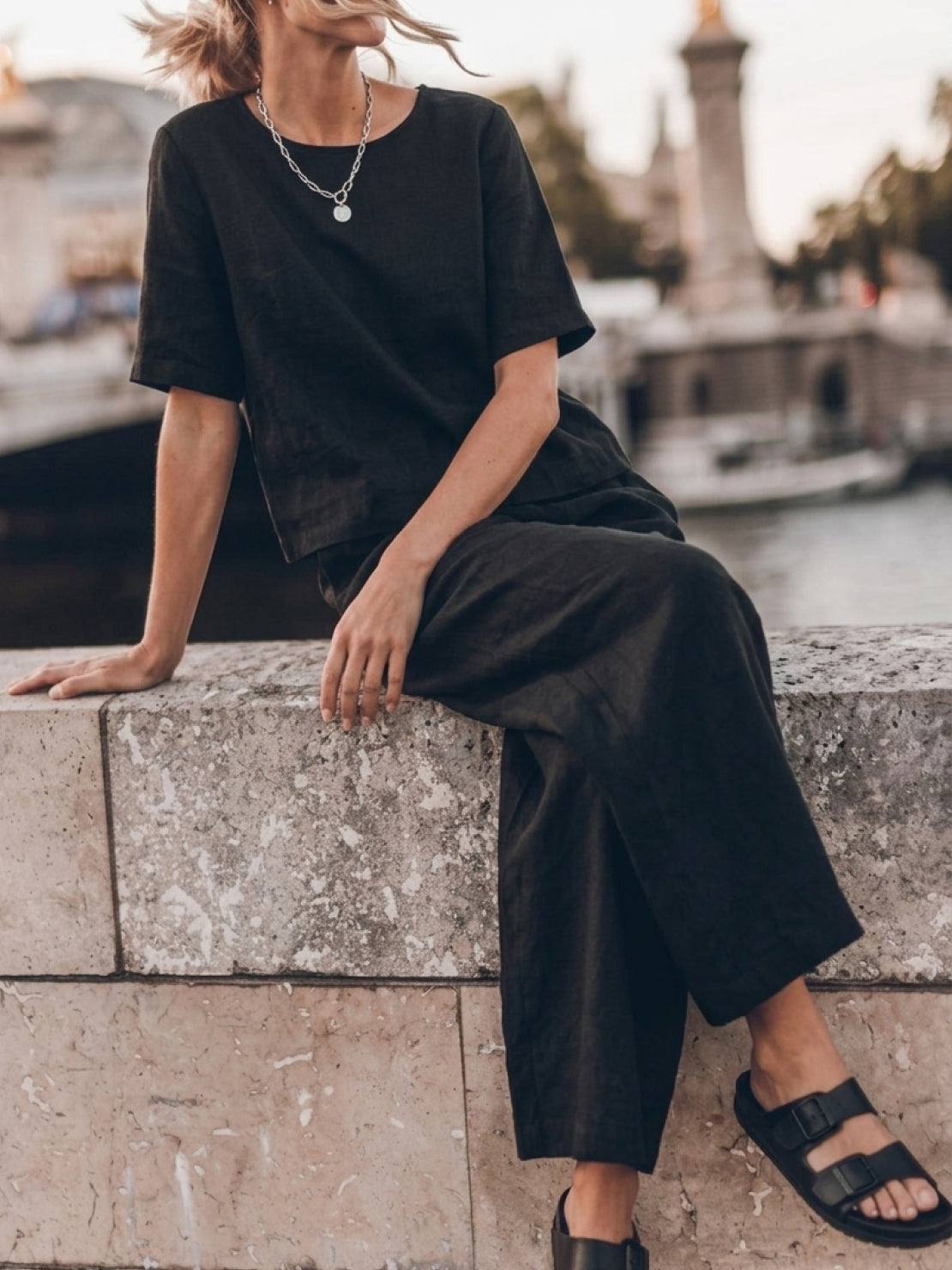 Woman wearing soft-tailored loose fit co-ord set with wide-leg cotton trousers and short sleeves in light fabric