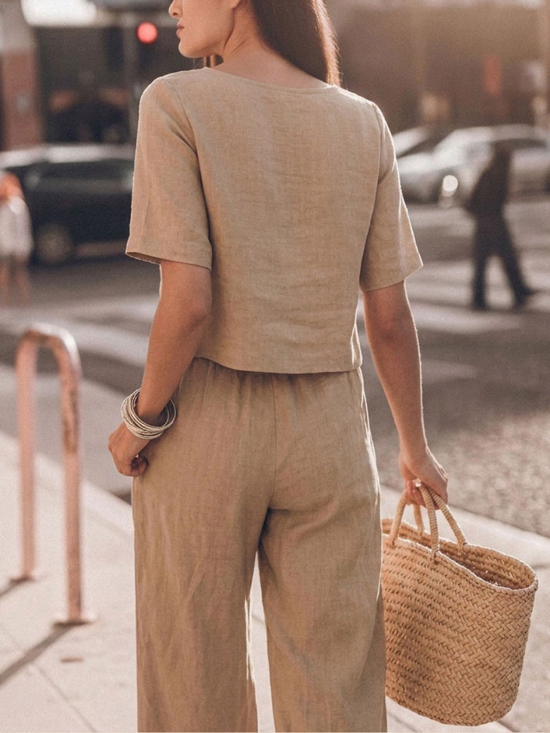 woman wearing loose fit co-ord set with soft-tailored top and wide-leg bottoms in light cotton fabric