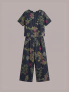 Light beige loose fit co-ord set with soft-tailored top and wide-leg cotton trousers displayed on plain background