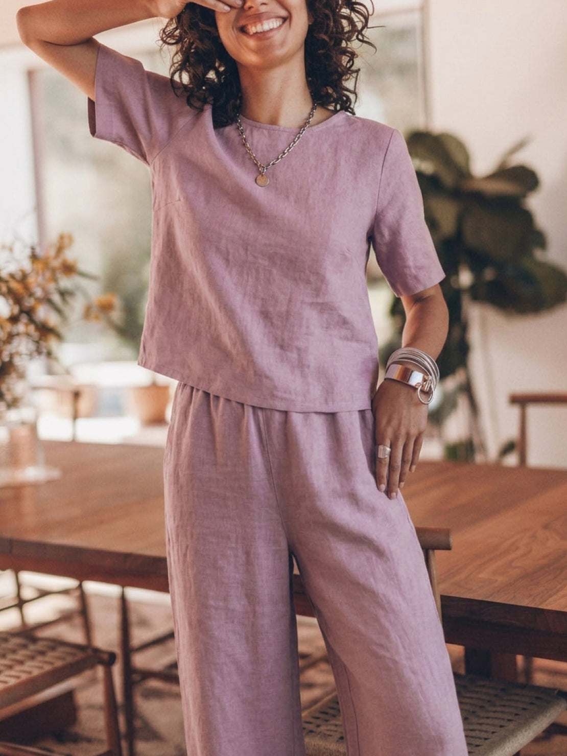 Woman wearing a loose fit co-ord set with soft-tailored top and wide-leg bottoms in breathable cotton