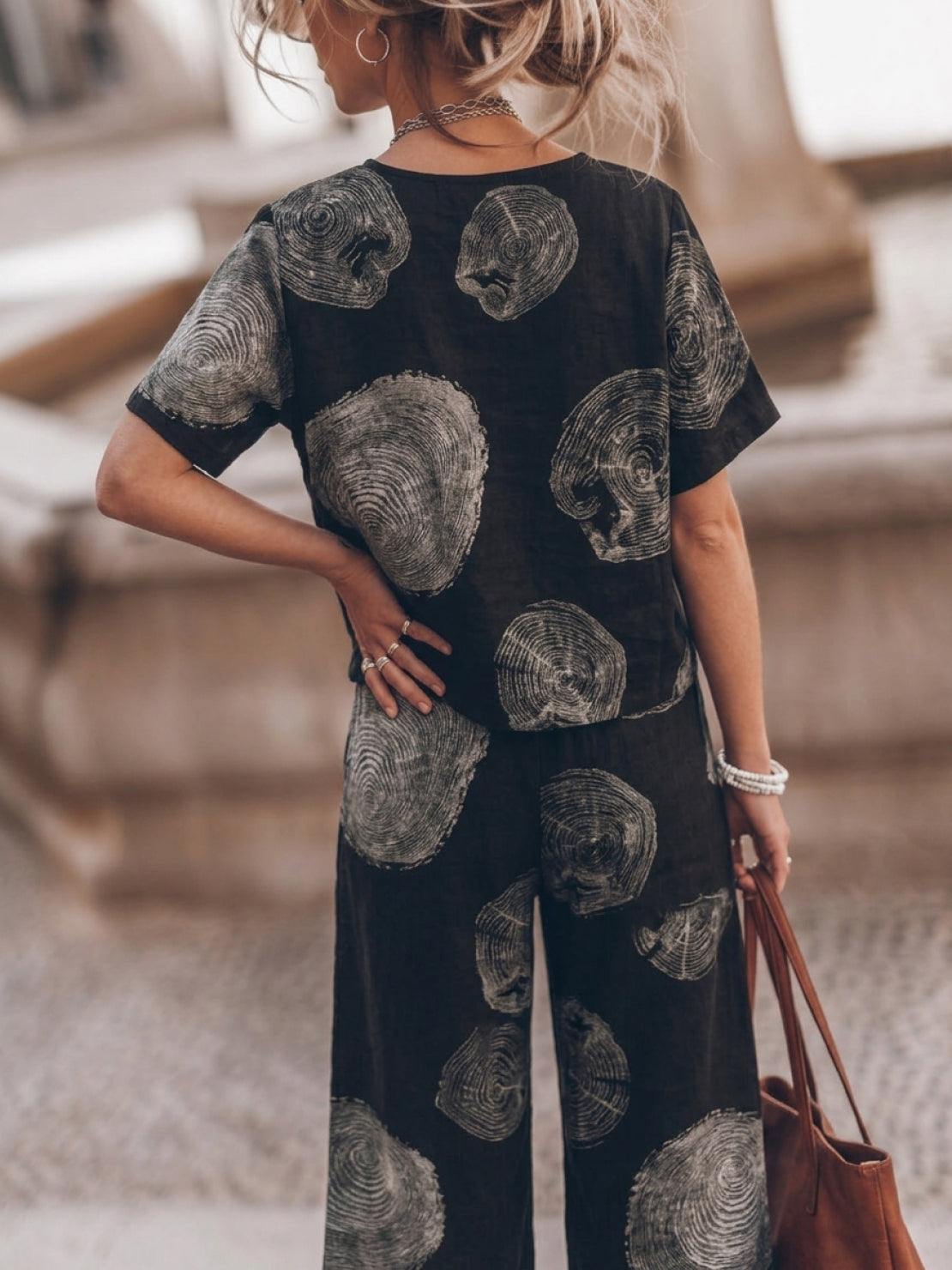 Woman wearing a white soft-tailored loose fit co-ord set with wide sleeves and wide-leg trousers, styled for casual comfort