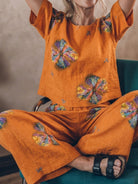 woman wearing loose fit co-ord set with short sleeves and wide-leg cotton trousers