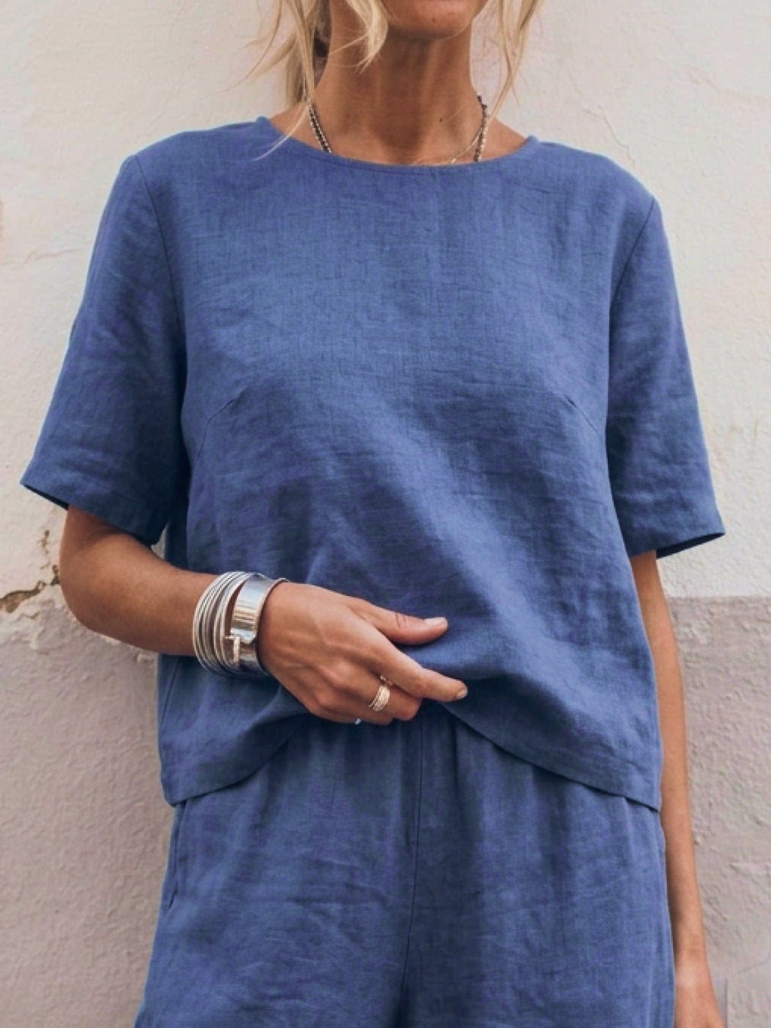 Woman wearing a soft cotton loose fit co-ord set with wide-leg trousers and a relaxed short-sleeve top