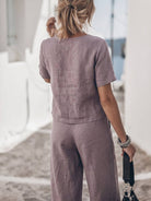 Woman wearing a soft cotton loose fit co-ord set with relaxed top and wide-leg bottoms in a light neutral color